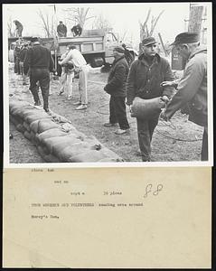 Town Workers and Volunteers sandbag area around Morey's Dam.