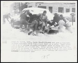 New Haven, Conn - Heave - And out goes a blizzard-stranded motorist today from a snow drift at a curb. Those seven boys took to helping stranded motorists after learning that high school classes were called off. After getting above car out, they romped off in search of others buried in the foot of new snow which fell today in the second blizzard since Friday.