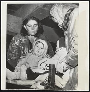 Quarters cramped below decks. Mothers give first thoughts to comfort their young below decks as more than 850 immigrants settle for trip.