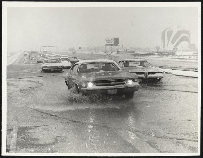 Flooding on southbound lane of Southeast Expressway slows traffic to a crawl. More than a few cars stalled out on the expressway because of water and slush.