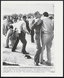 Westville, N.J. -- Picket Line Clinch -- This is scene of malee when oil workers crossed picket line of maritime workers at the Texaco refinery near Westville, NJ., friday morning. Policeman (left) restrains union member. In the foreground, another sign-carrying picket is involved in struggle with an officer.