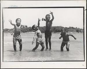 James, Ronald, Jarrod and Damion jumping at the beach