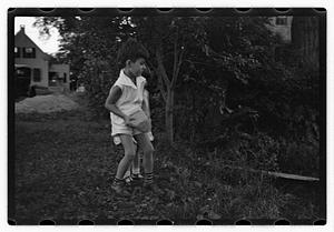 A boy holding a rock