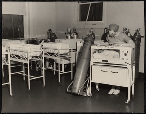 Nurse monitoring baby in incubator at Faulkner Hospital