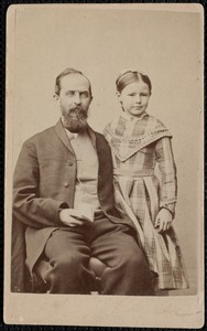 Dr. George Faulkner holding a book with his daughter Mary