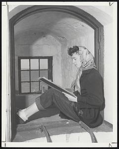 Window Bay shows strength of massive masonry walls, eight feet thick at the base. Mrs. Clinton Davis finds it a comfortable place to scan the island's guest book.