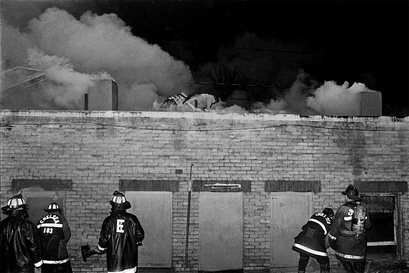 Chelsea and Everett firefighters working in the rear of the pharmacy