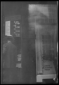 Man looking in cigar store window, Boston