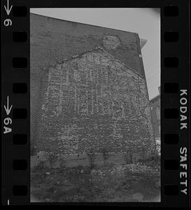 Outline of an old building on a brick wall