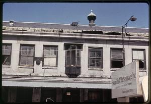 Dilapidated Quincy Market, sign reading "Faneuil Hall Marketplace, Inc." in foreground