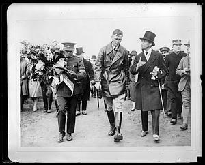 Charles Lindbergh walking with two other people