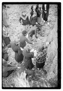 A group of young women cooking food on a fire