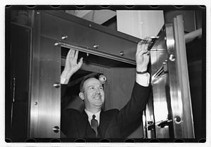A man demonstrating how to break into a safe