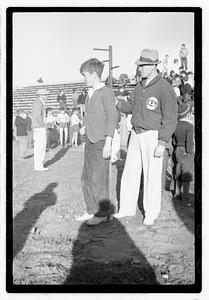A boy standing by a crowd