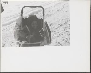 Boy in a stroller in winter
