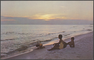 A man, a woman and a girl on the beach