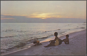 A man, a woman and a girl on the beach
