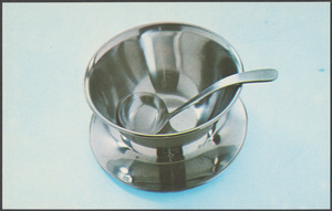 A dish on a tray with a ladle inside