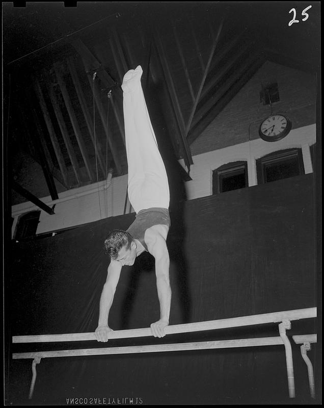 SC gymnast doing handstand on parallel bar