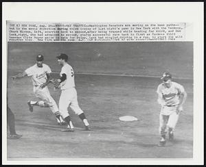 Wrong-Way Traffic--Washington Senators are moving on the base paths--but in the wrong direction during third inning of last night's game in New York with the Yankees. Chuck Hinton, left, scurries back to second, after being trapped while heading for third, and Don Lock, right, who had advanced to second, starts successful race back to first as Yankees third baseman Clete Boyer waits in vain for relay. Lock had singled, driving in a run, to start the wild run-down play. New York won the game 4-1.