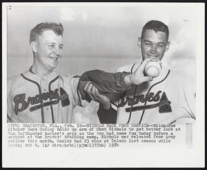 Bradenton, Fla. – Nichols Back From Service – Milwaukee pitcher Gene Conley holds up arm of Chet Nichols to get better look at the lefthanded hurler’s grip as the two had some fun today before workout at the Braves’ training camp. Nichols was released from Army earlier this month. Conley had 23 wins at Toledo last season while losing but 9.