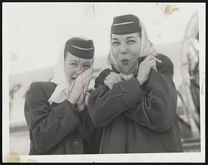 Shivering as she steps off plane from New York today is American Airlines stewardess Eleanor Page of Pittsburgh.