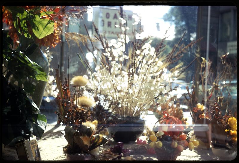 Flowers arrangements in a vase in a store window