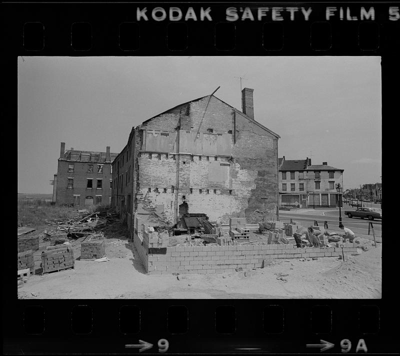 Construction workers building cinderblock wall in Market Square