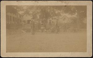 Road crew working on street in front of houses