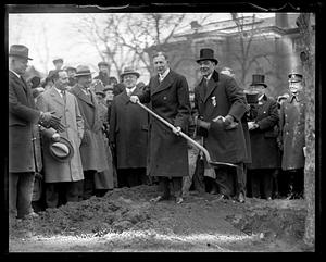 An unidentified man holding a shovel, possibly at a ground breaking