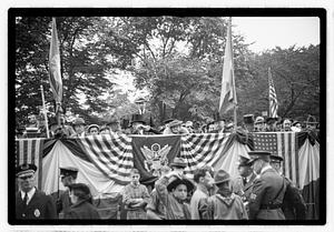 A group of people seated on a reviewing stand including Boston Parks Commissioner William Long