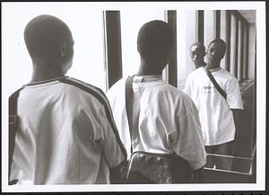 Two young men looking in the mirror
