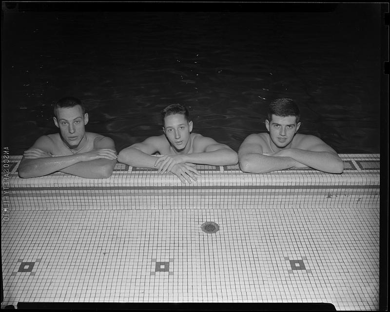 Three swimmers at the side of McCurdy Natatorium