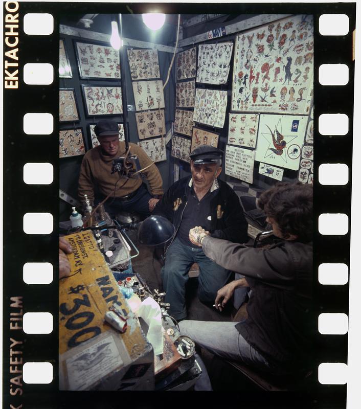 Stoic tattoo customer at county fair, Rochester, NH Digital Commonwealth