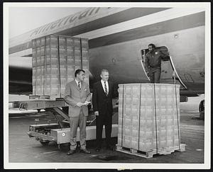Alfred A. Ackerman, right, district sales manager for American Airlines and Allan R. Nagle, executive vice-president, Gillette Safety Razor Co., oversee loading of Gillette's new Platinum-Plus razor blades on an American Astrojet which will take the shipment to Los Angeles.