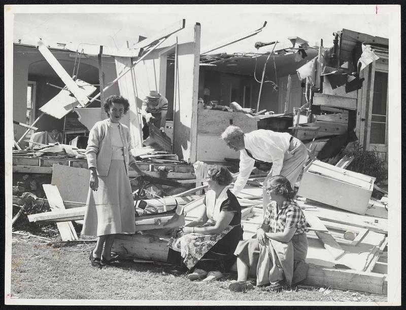 Shrewsbury Tornado Damage-The Coppage family, and friends, gaze at all that is left of their 21-inch TV set and cottage at 27 Lake St., Shrewsbury. Left to right, Mrs. Clyde Coppage, Mrs. Raymond K. Gilmore, Clyde Coppage (in rear), and Miss Elizabeth Brunell.