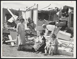 Shrewsbury Tornado Damage-The Coppage family, and friends, gaze at all that is left of their 21-inch TV set and cottage at 27 Lake St., Shrewsbury. Left to right, Mrs. Clyde Coppage, Mrs. Raymond K. Gilmore, Clyde Coppage (in rear), and Miss Elizabeth Brunell.