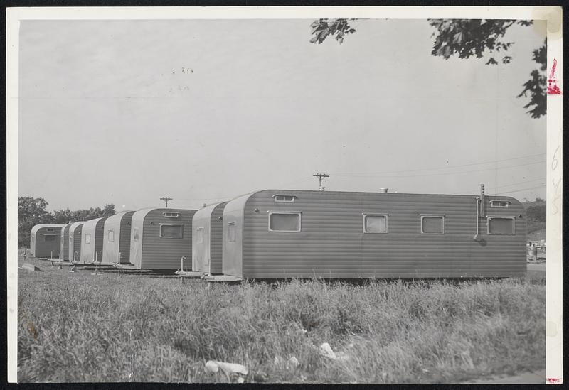 Tornado Aftermath - The beginnings of a trailer camp (above) spout at Worcester near the tornado-smashed Lincolnwood housing project. Hundreds more trailers are due here for the homeless. Below: Workmen burn some of the splintered ruins of homes.