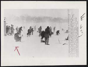 Never Too Cold to Fish -- Braving winds up to 40 miles per hour with the temperature near the 10 below zero mark, more than 700 fishermen and women tried their hand at angling through the ice today in an American Legion fishing contest. Photo shows some of the anglers on Lake Minnetonka where a one-pound, nine-ounce northern pike took the $100 first prize.