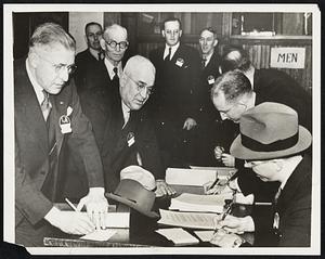 Justices of Peace Study at Hobart. Geneva, N.Y.--Some of the three hundred Justices of the Peace of New York State, representing forty-eight counties, registering for the four-day school at Hobart College. The course is a part of the college's program of education for for responsible citizenship. Left to right: C.H. Flanagan, Manlius, N.Y.; C.D. Bingham, Camilus, N.Y.; O.H. White and T.N. Hurd, both of Cornell University.