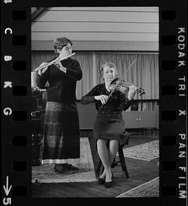 Lea Pearson playing flute and Florence Pearson playing violin