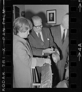 William Perkins, chief of the engineering division of the Veterans Hospital, Jamaica Plain, shows Representative Margaret Heckler some new aluminum siding engineers will install in the hospital walls to reflect heat from radiators