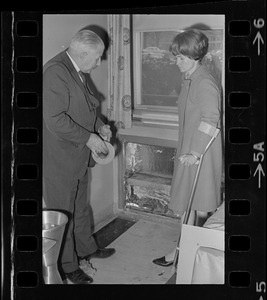 William Perkins, chief of the engineering division of the Veterans Hospital, Jamaica Plain, shows Representative Margaret Heckler some new aluminum siding engineers will install in the hospital walls to reflect heat from radiators