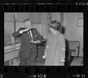 William Perkins, chief of the engineering division of the Veterans Hospital, Jamaica Plain, shows Representative Margaret Heckler some new aluminum siding engineers will install in the hospital walls to reflect heat from radiators