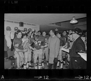 Boston College football team, including player Dave Bennett and coach Joe Yukica, center, celebrate victory over Holy Cross