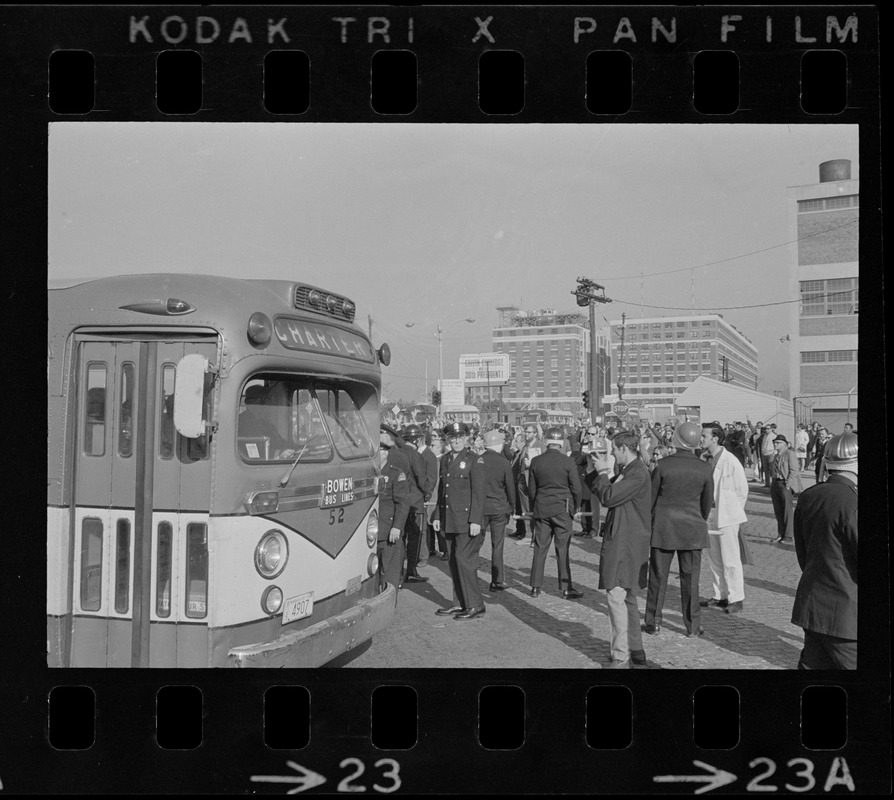 Boston Police protecting bus carrying draftees at anti-war protest at Boston Army Base