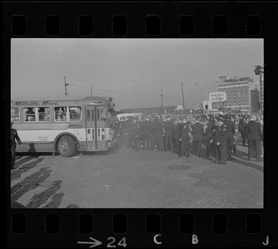 Boston Police protecting bus carrying draftees at anti-war protest at Boston Army Base