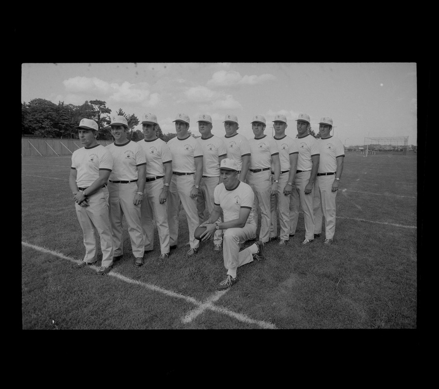 Coach Joe Yukica (kneeling) and Boston College coaching staff