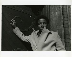 Teenage boy posing in front of ornate door