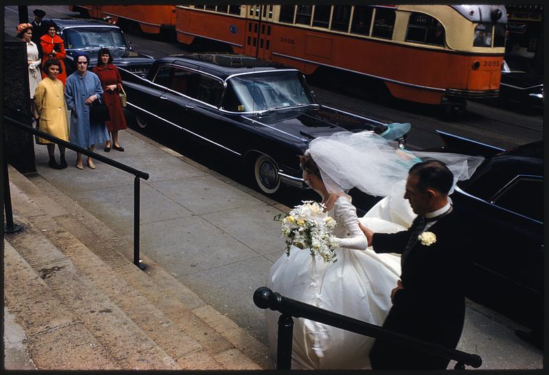 Bride and others at foot of steps by street, Jamaica Plain, Massachusetts